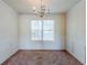 Dining area with wainscoting and classic chandelier; bright natural light at 445 Skif Pond Ct, Atlanta, GA 30349