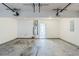 Spacious garage interior with door to house, featuring ample space and utility connections at 445 Skif Pond Ct, Atlanta, GA 30349