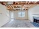 Open living room area featuring a fireplace and unfinished ceiling at 445 Skif Pond Ct, Atlanta, GA 30349