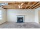 Living room with fireplace and exposed ceiling; ready for finishing at 445 Skif Pond Ct, Atlanta, GA 30349