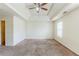 Spacious main bedroom with tray ceiling and fan fixture, offering comfort and modern style at 445 Skif Pond Ct, Atlanta, GA 30349