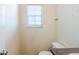 Cozy powder room featuring a small window, toilet, and vanity with solid surface countertop at 445 Skif Pond Ct, Atlanta, GA 30349