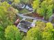 Aerial view of a home nestled in a beautiful wooded area, and showcasing a large concrete patio at 4960 Trevino Cir, Duluth, GA 30096