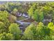 Aerial view of a home nestled in a beautiful wooded area, surrounded by lush greenery at 4960 Trevino Cir, Duluth, GA 30096