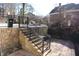 Backyard with stone staircase, black iron fence, leading to a patio at 4960 Trevino Cir, Duluth, GA 30096