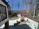 Backyard with a custom stone outdoor fireplace, fenced yard, lush landscaping, and a storage shed at 4960 Trevino Cir, Duluth, GA 30096