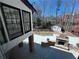 A large backyard with a stone fireplace, patio, fenced yard, and a storage shed at 4960 Trevino Cir, Duluth, GA 30096