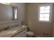Bathroom features a white vanity, decorative mirror and window with natural light at 4960 Trevino Cir, Duluth, GA 30096