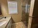 Bathroom features a glass door shower, vanity with tile and a window allowing for natural light at 4960 Trevino Cir, Duluth, GA 30096