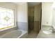 Bathroom with soaking tub, walk-in shower, and decorative stained glass window at 4960 Trevino Cir, Duluth, GA 30096
