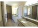 Bathroom with dual sinks, soaking tub, and decorative stained glass window at 4960 Trevino Cir, Duluth, GA 30096