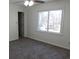 Bedroom showcasing a carpeted floor, a door to the left and large window at 4960 Trevino Cir, Duluth, GA 30096