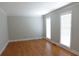 Well-lit bedroom featuring hardwood floors, crown molding, and windows with natural light at 4960 Trevino Cir, Duluth, GA 30096