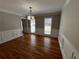 Formal dining room boasts hardwood floors, wainscoting, crown molding, and modern light fixture at 4960 Trevino Cir, Duluth, GA 30096