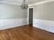 Dining room features hardwood floors, wainscoting, crown molding, and a geometric light fixture at 4960 Trevino Cir, Duluth, GA 30096