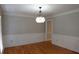 Formal dining room features beautiful hardwood floors and modern light fixture at 4960 Trevino Cir, Duluth, GA 30096