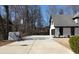 Wide driveway with a basketball hoop and a view of the side of the home and attached garage at 4960 Trevino Cir, Duluth, GA 30096