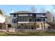 Exterior view of a home featuring a large backyard with stone pillars, a covered patio, and an exterior staircase at 4960 Trevino Cir, Duluth, GA 30096