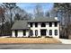 Charming two-story home features a classic white exterior with dark trim and a well-manicured lawn at 4960 Trevino Cir, Duluth, GA 30096