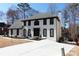 Beautiful two-story home features a classic white exterior with dark trim and a spacious driveway at 4960 Trevino Cir, Duluth, GA 30096