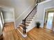 Entryway with wood floors and decorative stairs leading to the second level at 4960 Trevino Cir, Duluth, GA 30096