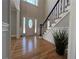Bright foyer features hardwood floors, a staircase with decorative iron railings, and a front door with sidelights at 4960 Trevino Cir, Duluth, GA 30096