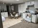 Kitchen area with tile floors, white cabinetry, stove and small dining table at 4960 Trevino Cir, Duluth, GA 30096
