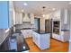 Bright kitchen featuring white cabinetry, stainless steel appliances and granite counters at 4960 Trevino Cir, Duluth, GA 30096