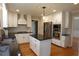 Kitchen area showcasing a kitchen island with granite countertops and wooden floors at 4960 Trevino Cir, Duluth, GA 30096