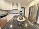 Island kitchen showcasing granite counters, modern appliances and white cabinets at 4960 Trevino Cir, Duluth, GA 30096