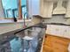Beautiful kitchen with granite countertops, stainless steel sink, and an elegant backsplash at 4960 Trevino Cir, Duluth, GA 30096