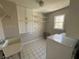 Bright laundry room featuring tile flooring, washer, dryer, and ample storage cabinets at 4960 Trevino Cir, Duluth, GA 30096