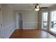 Cozy living room with hardwood floors, ceiling fan, large windows, and natural light at 4960 Trevino Cir, Duluth, GA 30096