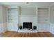 Living room featuring a fireplace with built-in bookshelves and hardwood floors at 4960 Trevino Cir, Duluth, GA 30096