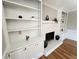 Living room showcasing a brick fireplace with built-in bookshelves and hardwood floors at 4960 Trevino Cir, Duluth, GA 30096