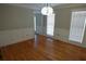 Living room features hardwood floors, white trim, and two windows with natural light at 4960 Trevino Cir, Duluth, GA 30096