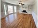 Spacious living room with hardwood floors, a brick fireplace and built-in bookshelves at 4960 Trevino Cir, Duluth, GA 30096