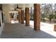 Spacious patio with stone pillars, black metal fencing, and ceiling fans providing a stylish and comfortable outdoor space at 4960 Trevino Cir, Duluth, GA 30096