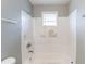 Bathroom with a shower-tub combo and a window above at 202 Nathan Sw Rd, Atlanta, GA 30331