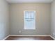 Bedroom featuring a double-hung window and wood-look floors at 202 Nathan Sw Rd, Atlanta, GA 30331