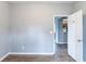 Bedroom has a gray walls, wood-look floors, and a glimpse of the kitchen at 202 Nathan Sw Rd, Atlanta, GA 30331