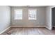 Bedroom featuring laminate flooring and two windows at 202 Nathan Sw Rd, Atlanta, GA 30331