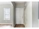 View of the entryway with wood floors, a window with blinds and a white six-panel door at 202 Nathan Sw Rd, Atlanta, GA 30331