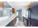 Functional kitchen featuring tile countertops, wood cabinets, and essential appliances for cooking convenience at 202 Nathan Sw Rd, Atlanta, GA 30331