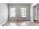 Open living space with two windows and wood flooring, offering natural light and a modern feel at 202 Nathan Sw Rd, Atlanta, GA 30331