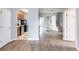 View of the living room, kitchen and staircase featuring hardwood floors and neutral colored paint at 202 Nathan Sw Rd, Atlanta, GA 30331