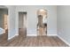 View of the living room with wood floors and an arched doorway that leads to the kitchen at 202 Nathan Sw Rd, Atlanta, GA 30331