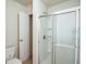 Bathroom featuring a shower with a glass door and a toilet at 2453 Suwanee Pointe Dr, Lawrenceville, GA 30043