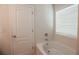 Bright bathroom features a bathtub under a window, providing natural light at 2453 Suwanee Pointe Dr, Lawrenceville, GA 30043
