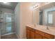 Bathroom featuring a double sink vanity and a glass-enclosed shower at 2453 Suwanee Pointe Dr, Lawrenceville, GA 30043